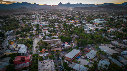 drone fly above Loreto Baja California Sur Mexico old colonial town with sea gulf ocean and mountains desert landscape at sunset