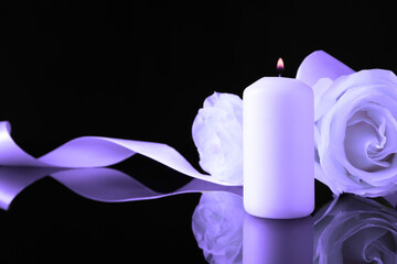 Poster - Violet roses and burning candle on black mirror surface, space for text. Funeral attributes