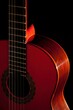 © Robert Peak - Classical Spanish flamenco guitar close up, dramatically lit isolated on black background with copy space.