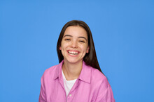 Smiling Pretty Freckled Gen Z Brunette Latin Girl, Cute Happy Hispanic Teen Student Wearing Pink Shirt Looking At Camera Laughing Standing Isolated On Blue Background. Close Up Portrait.