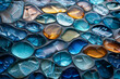 Background of blue and orange stones on a surface. The stones are of various sizes and shapes, and they appear to be arranged in a pattern