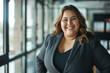Portrait of A Smiling Chubby Latina Businesswoman In Her Office. Full-Figured Latina Businesswoman. Chubby Latina CEO And Entrepreneur Woman