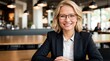Businesswoman in stylish specs smiles at bright cafe table 