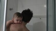 © Marco - Dad holding baby son infant in shower bathing and cleaning