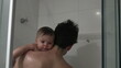 © Marco - Dad holding baby son infant in shower bathing and cleaning