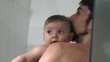 © Marco - Father holding baby son infant toddler in shower