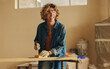 © Jacob Lund - Smiling mature woman renovating kitchen with hand tools and woodwork upgrades