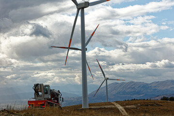 Wall Mural - Wind farm or wind park at sunset located in the mountains of Italy Europe to realize clean energy. It’s sustainable, renewable energy for enviromental. Iconic location for landscape photographers blog