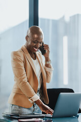 Wall Mural - Happy business woman speaking on phone in a corporate office