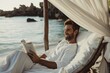Content male enjoys a book in a serene beachfront setting, illustrating leisure and peace
