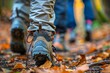 tourists walk along the path of the autumn forest, feet close-up