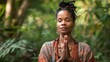 © ChaoticMind - Woman in vibrant attire and jewelry meditates in a lush green environment, signaling a connection with nature and inner peace