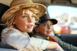 Two kids with hats looking outside a car window, reflecting joy and youthful curiosity