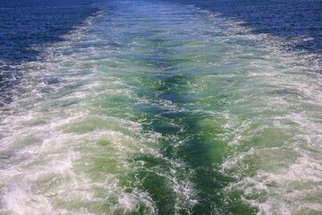 Wake in the sea Behind Big ship, prop wash of a tanker underway in open sea and blue water foam behind, Gulf of California, ocean, blue, vacation. Cruise Terminal The maritime terminal and Port Precin