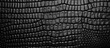 A detailed closeup shot of a grey automotive tire showcasing a textured black leatherlike pattern. The monochrome photography captures the intricate mesh design of the composite material