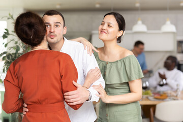 Wall Mural - Man and woman greet each other when meeting in kitchen at home