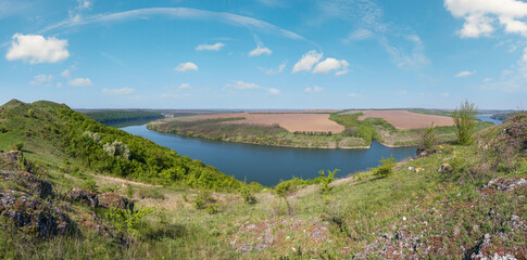 Wall Mural - Amazing spring view on the Dnister River Canyon with picturesque rocks, fields, flowers. This place named Shyshkovi Gorby,  Nahoriany, Chernivtsi region, Ukraine.