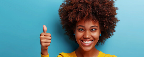 Wall Mural - Happy African American woman giving thumbs up on a solid background