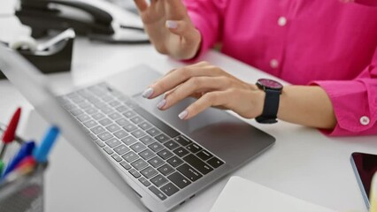 Sticker - A woman in a pink shirt experiences wrist pain while working on a laptop in an office setting.