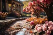 A stream flows by pink flowers in garden, with a house in the background