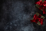 Fototapeta  - Two Golden Gift Boxes On Dark Background With Copy Space