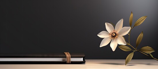 Canvas Print - A book and a flower on a wooden table