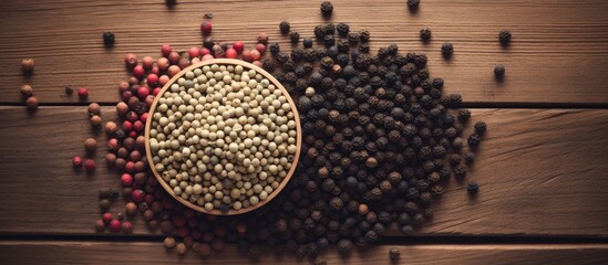 Canvas Print - Aromatic wooden spoon brimming with flavorful black pepper seasoning on a rustic backdrop