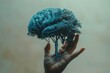 Hand Holding Miniature Tree With Brain