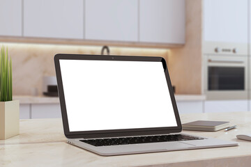 An open laptop with a blank screen sits on a modern kitchen counter, alongside a notebook and pen, ready for a recipe or website presentation. 3D Rendering