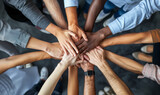 Fototapeta Sport - United in Purpose: Overhead View of Multiethnic Hands Together