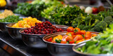 Fototapeta  - A line of metal bowls filled with colorful vegetables and salad at the entrance to an event hall,catering wedding buffet for events