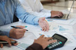 © ijeab - A team of business people is brainstorming to analyze investment project data.