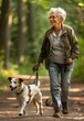 © Artlana - Happy senior woman walking dog.