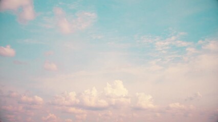 Wall Mural - A landscape with a panorama of clouds slowly floating into the distance with a slight pink tint. Romantic sky just after sunrise.