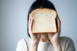 Gluten allergy, woman hand holding bread slice, refusing to eat, Gluten intolerant and Gluten free diet concept