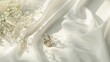 Wedding rings on white satin background. Wedding day concept.