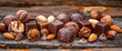 Assortment of chocolate candies with nuts on wooden background, closeup