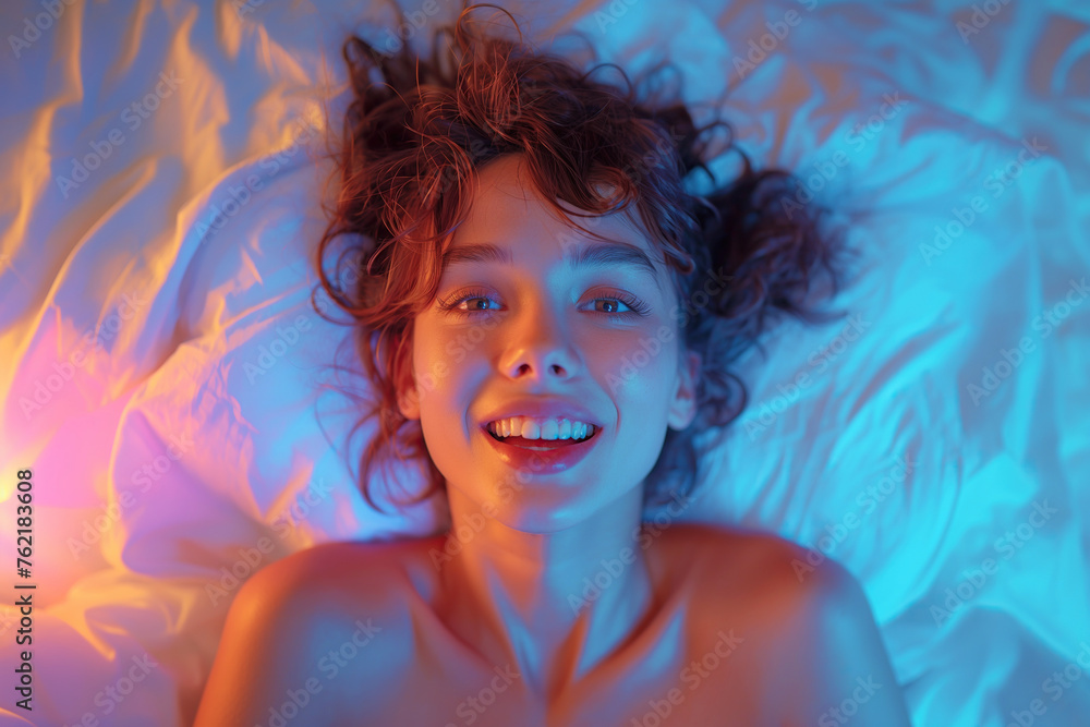 happy sexy young woman girl lying on bed having an orgasm while having ...