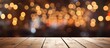 A wooden table with a warm amber hue sits against a blurred background of colorful Christmas lights. The tints and shades of the wood contrast beautifully with the festive city event lights