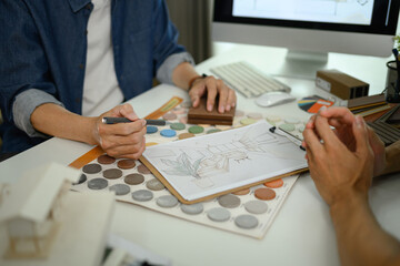 cropped shot of designer team working on a home renovation sketch at co working space in office