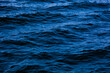 © kheartmanee - Blue ocean water with waves background. An abstract background of seawater flow under light exposure.