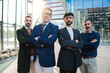 © Jose Calsina - Portrait of a group of real businessmen looking at camera with serious and confident expression. Successful male coworkers staring front. Masculine professional people. Meeting of corporate partners