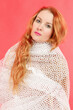 Portrait of a beautiful red-haired woman wrapped in a mesh cape
