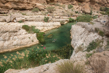 Wall Mural - Turquoise water flowing through the Wadi Shab canyon, Wadi Ash Shab, Oman