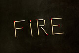Fototapeta Lawenda - Fire concept with fire text on black background top view