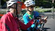 © Robert Peak - Closeup of senior and mature woman take a break while biking to look at a map on their phone for directions.