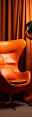 Minimalistic orange leather chair with a chrome base against an orange curtain background