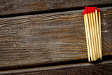Fototapeta Lawenda - Symbol of danger with matches on wooden background top view copyspace