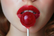 lollipop on a stick on background of a female face with sexy lips with red lipstick