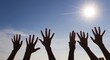 © Jayk - Raised up hands of many people on background of blue sunny sky closeup